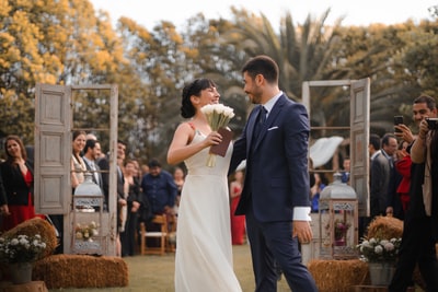 Standing beside the lantern of the newlyweds
